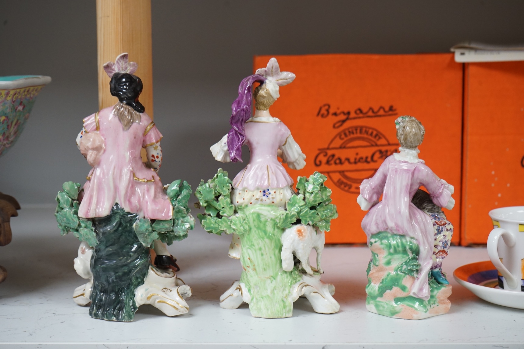A pair of Derby porcelain figures of musicians, and another of a lady and cat, late 18th century, largest 18cm high